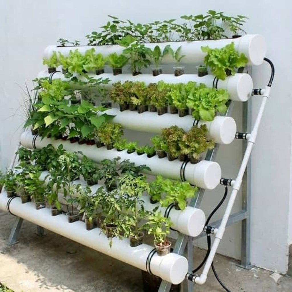 White PVC end caps mounted on a multi-tier plant grow pipe system