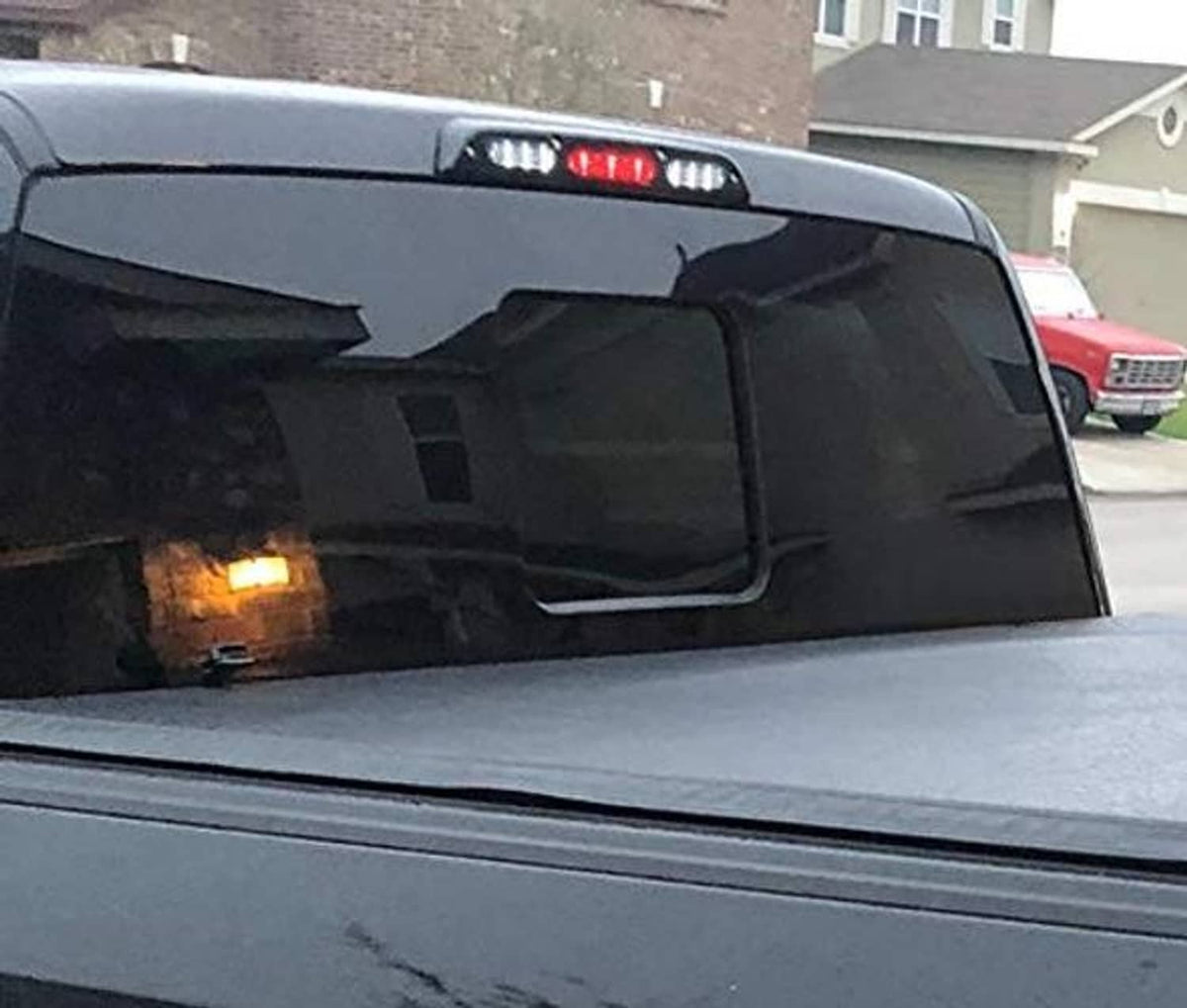 Close-up of smoked-lens LED high mount third brake light with red LEDs illuminated