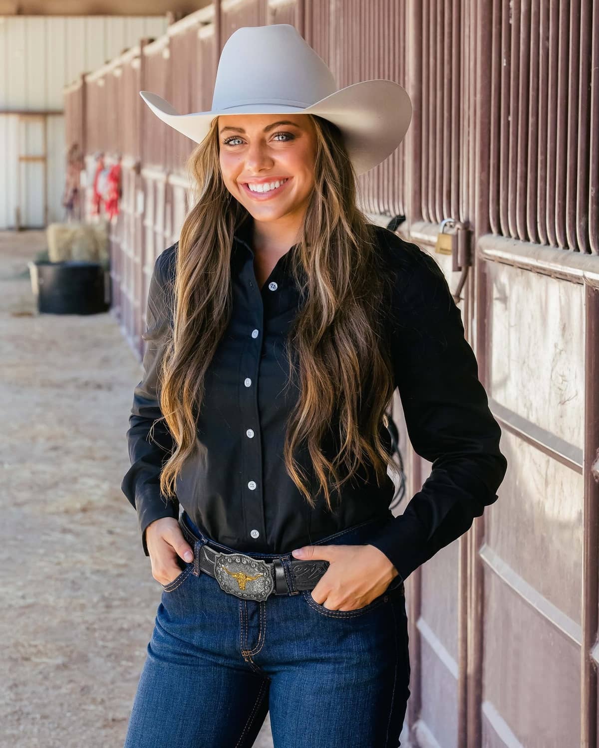 Western cowboy belt on torso: black leather strap with silver engraved buckle and gold bull center