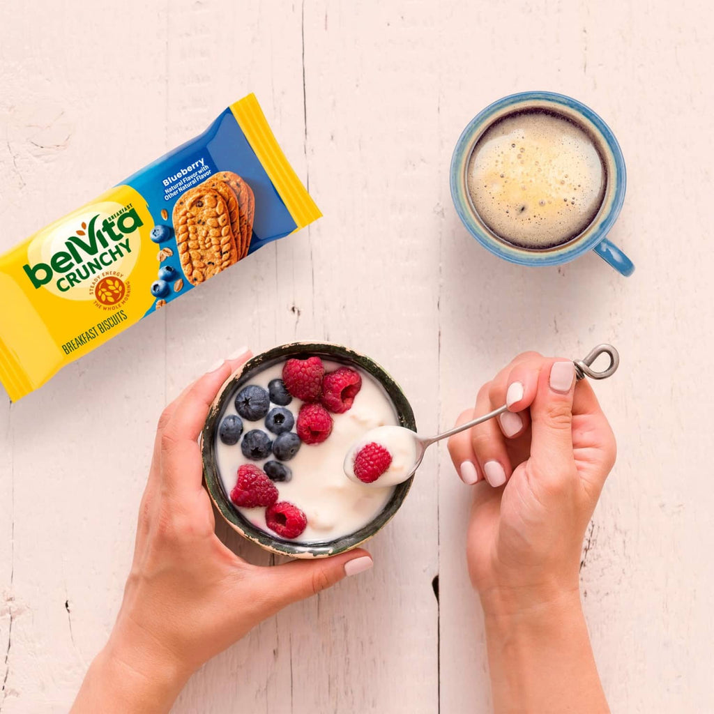 belVita Crunchy Blueberry biscuit pack next to yogurt bowl with berries