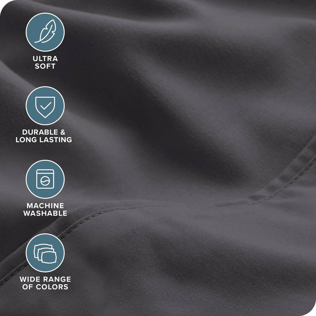 Grey microfiber sheet fabric close-up with smooth texture and neat stitching