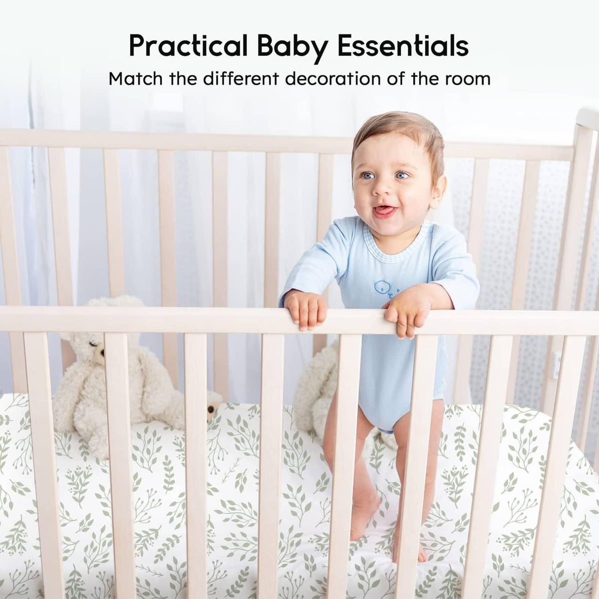 Fitted crib sheet with white leaf pattern and light green accents on a crib