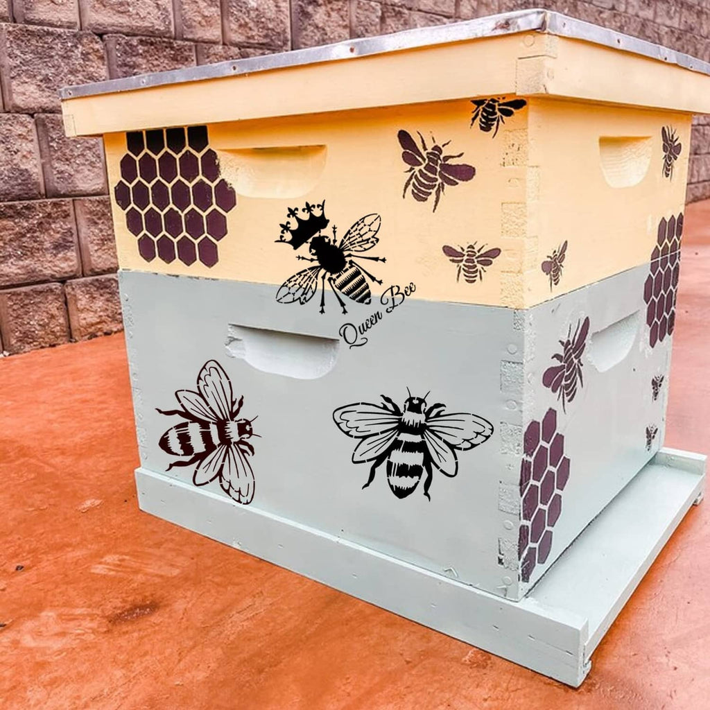 White beehive-style wooden box with black and purple bee and honeycomb stencil motifs