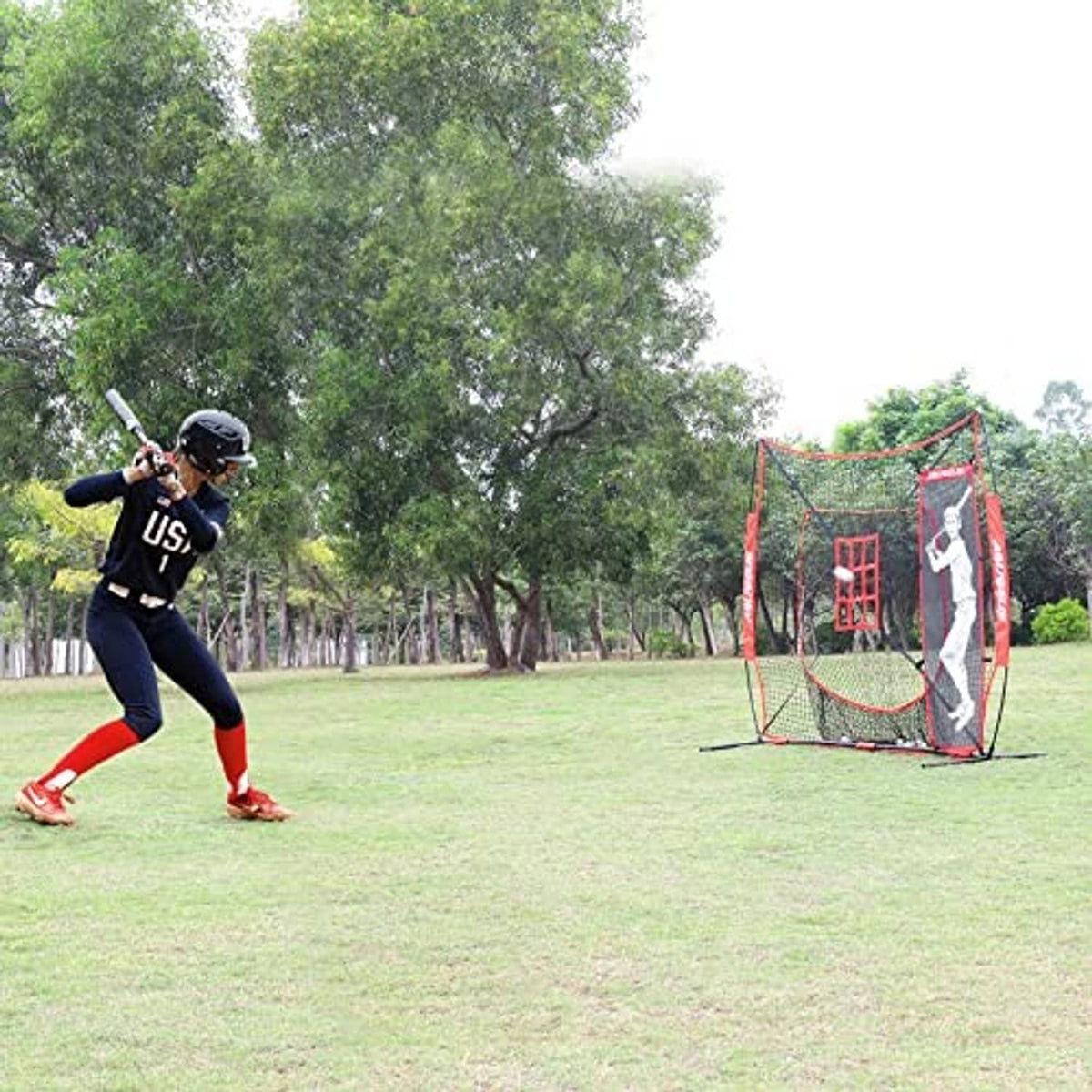 Baseball batting practice setup with red strike zone net and batter dummy target