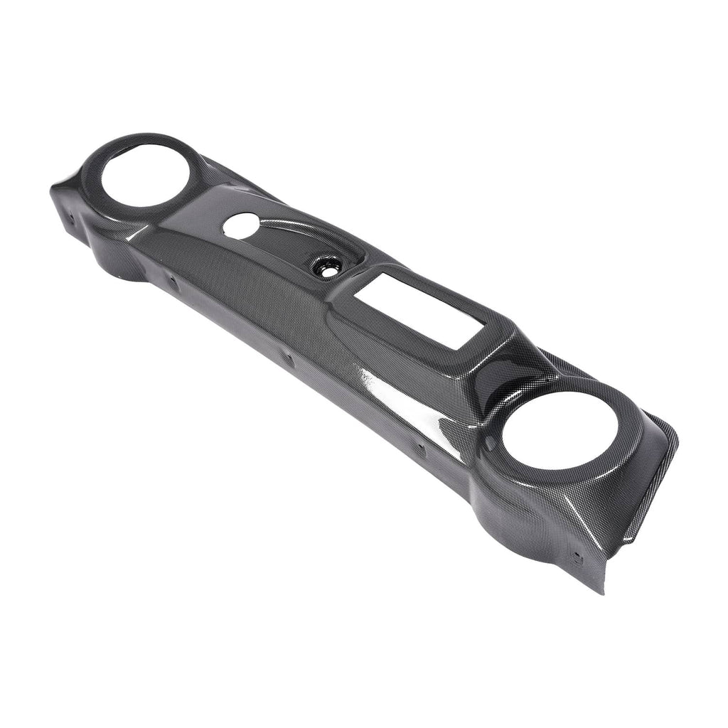 Black carbon-fiber style dash cover with round openings and center rectangular slot
