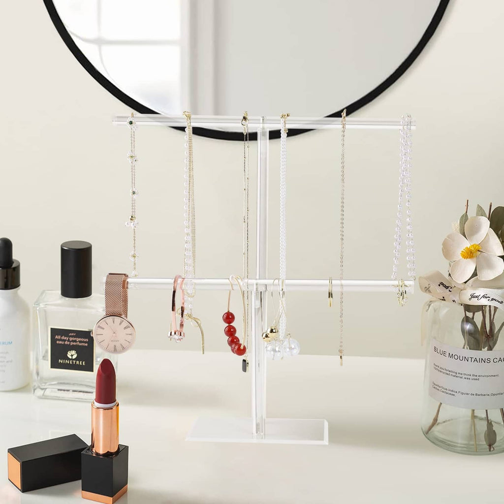 Clear acrylic necklace holder stand with rows of hanging jewelry chains