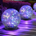 Solar glass globe lights, two blue-purple glowing spheres on black bases