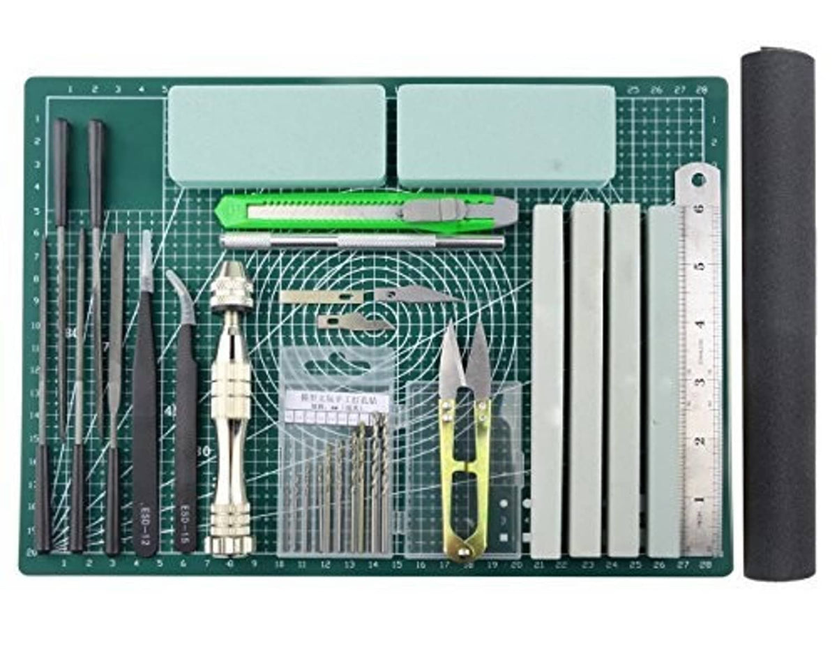 25-piece model tools kit on green cutting mat with assorted metal blades and rulers