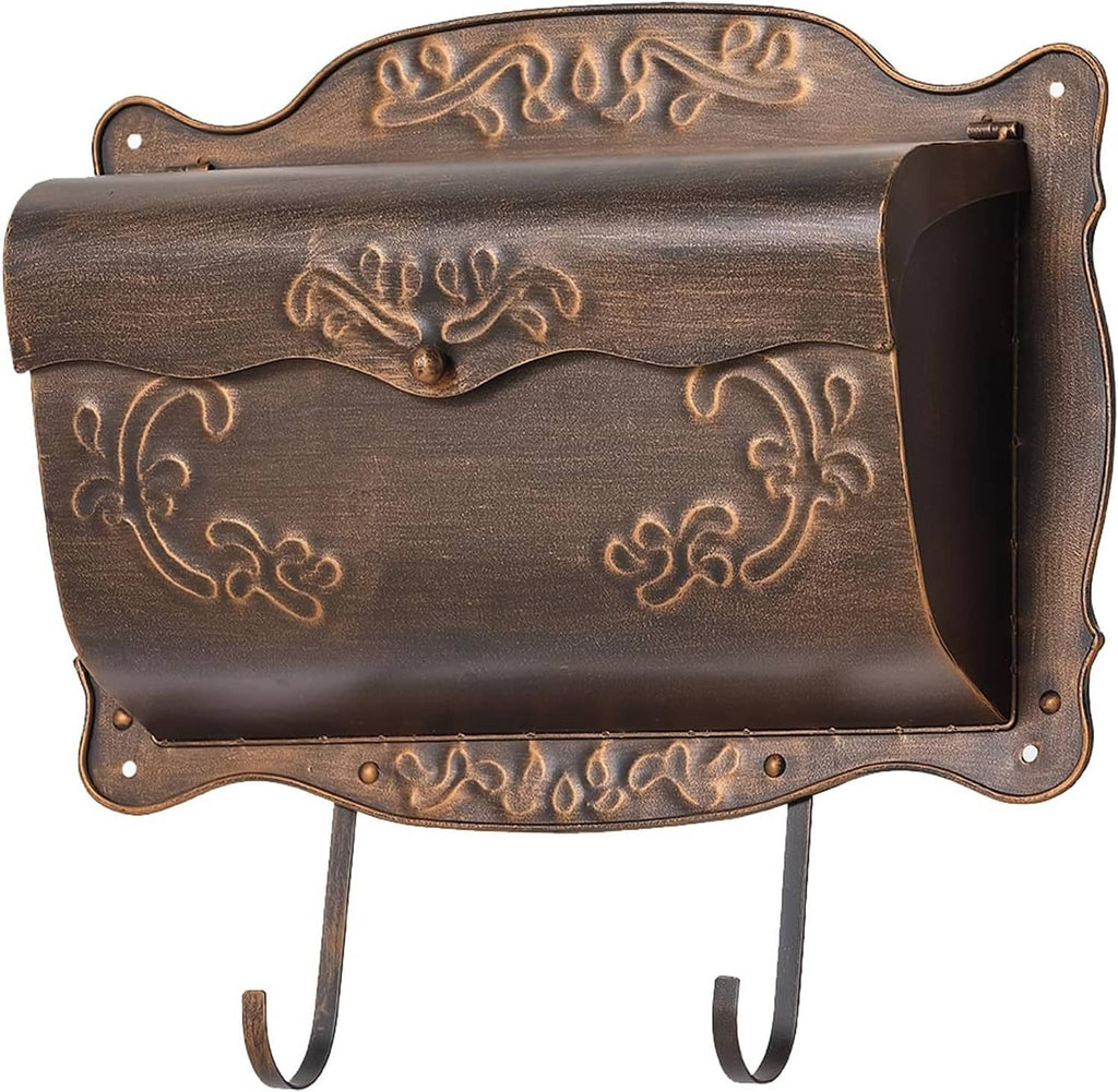 Vintage wall-mount metal mailbox in dark bronze with embossed floral trim and newspaper holder