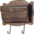 Vintage wall-mount metal mailbox in dark bronze with embossed floral trim and newspaper holder
