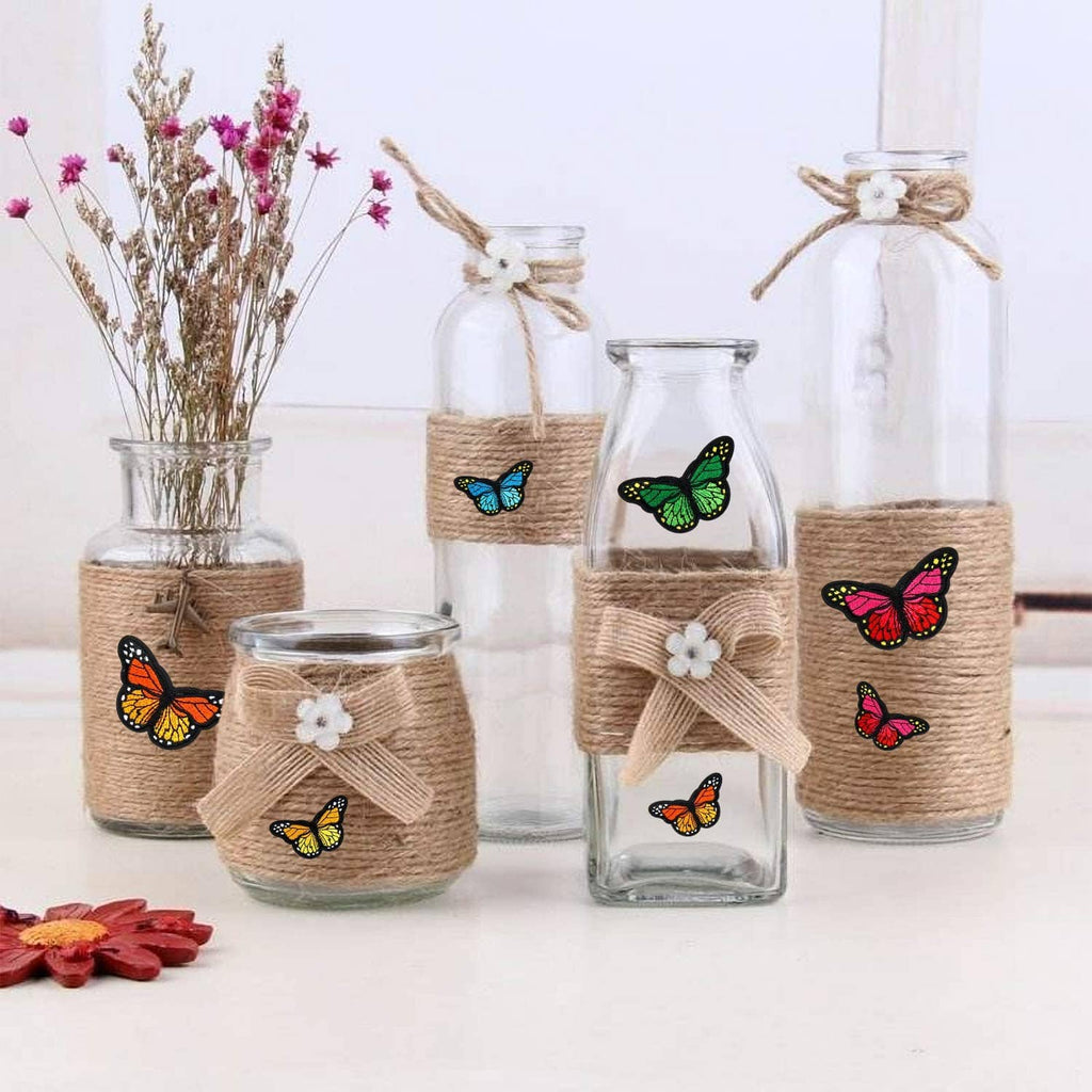 Butterfly iron-on patches on burlap-wrapped glass jars for decoration