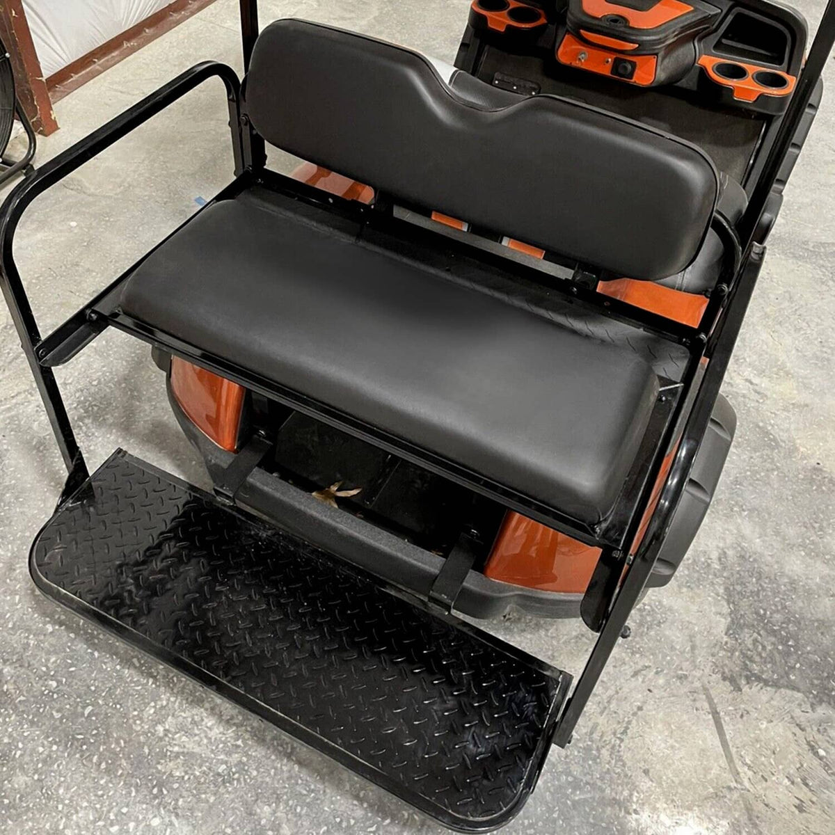 Rear view of black folding rear seat cushion pad with roof support and textured base