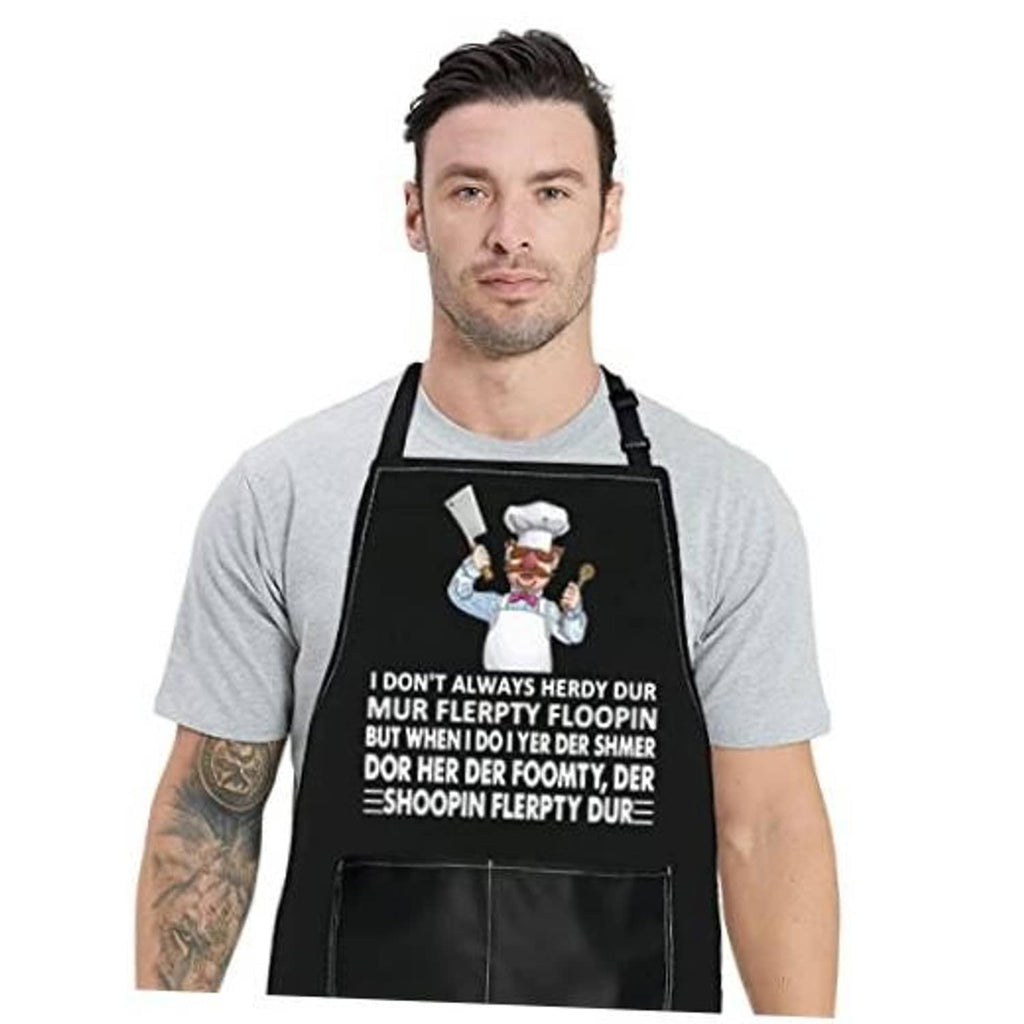 Black kitchen apron with chef graphic and slogan, adjustable neck, front pocket.