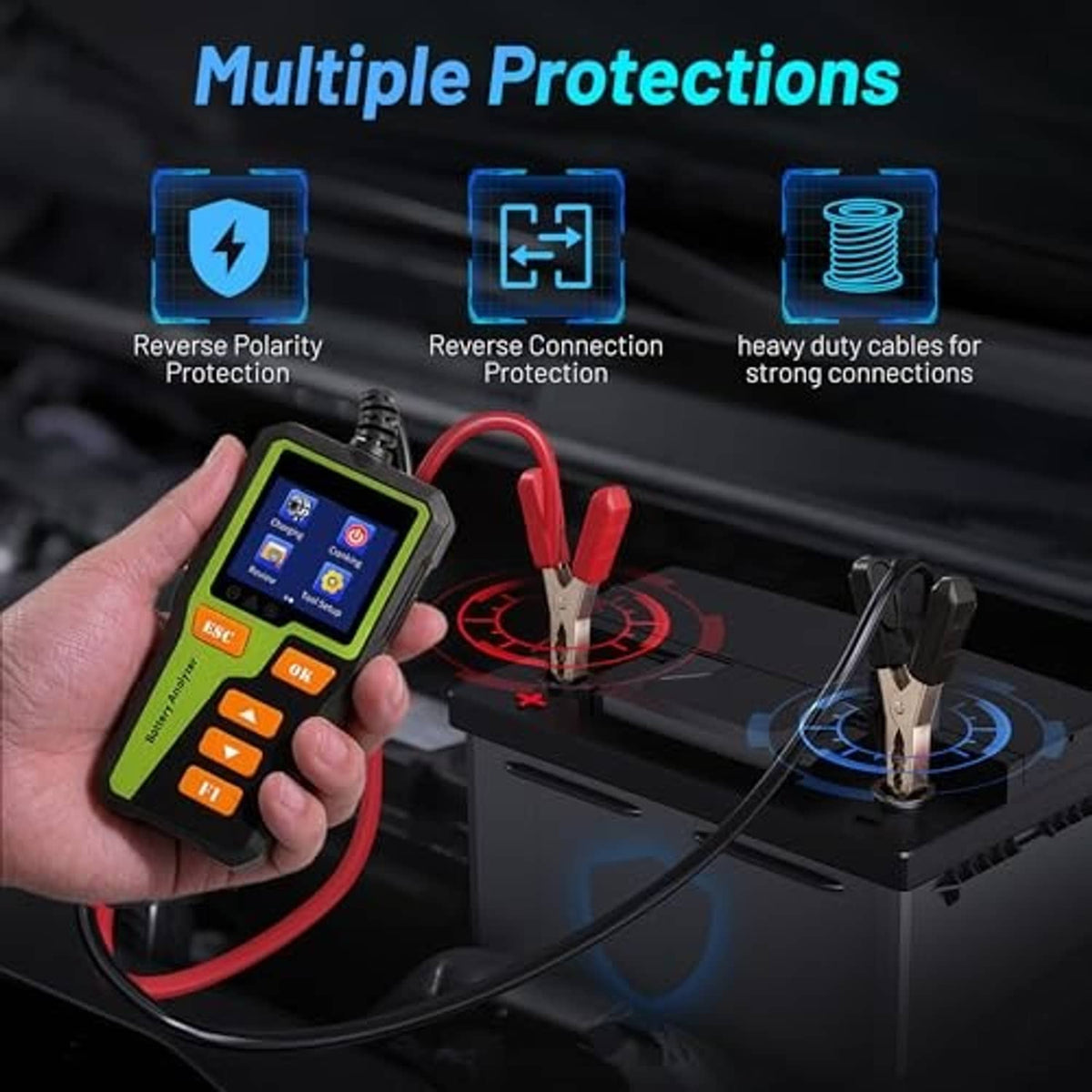 Car battery tester in hand with connected red and black leads and clips