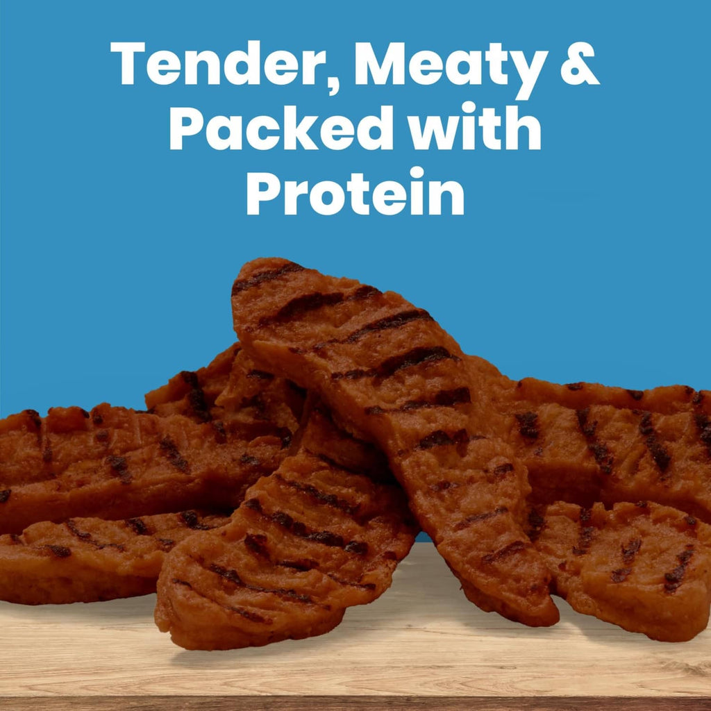 Brown grilled steak dog treats, tender meat sticks piled on a board