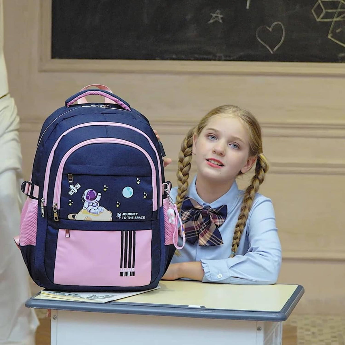 Navy and pink astronaut school backpack with pink trim and front zip pocket