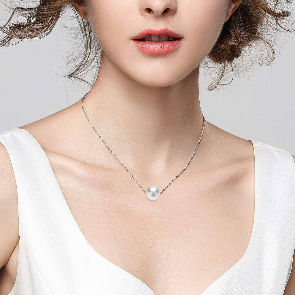 Silver-plated necklace chain with a single round pearl pendant worn at neckline.