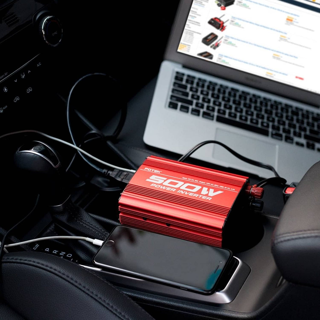 Red Potek 500W car power inverter plugged in under a dashboard near a laptop