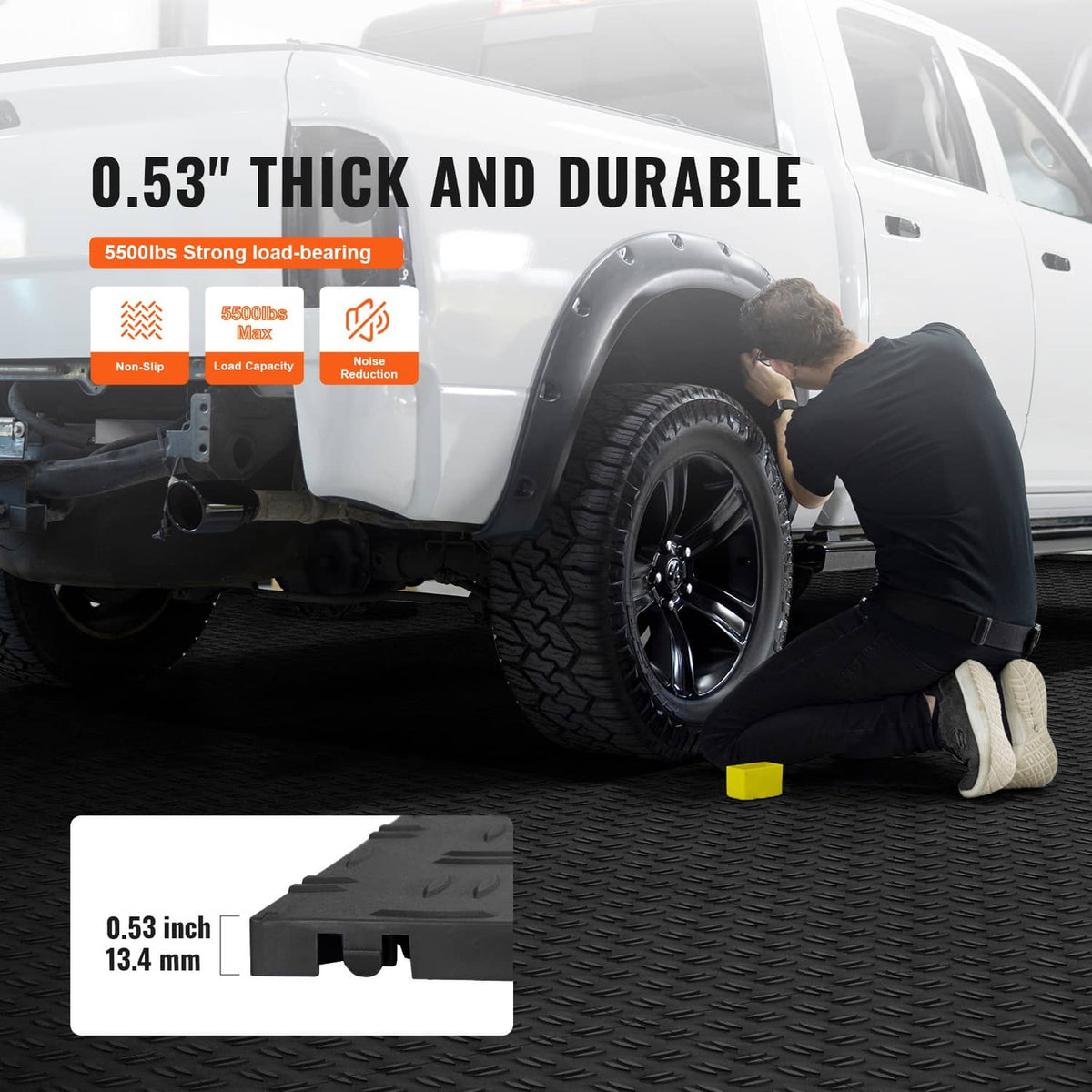 Black interlocking garage floor tiles with diamond tread texture and corner interlocks