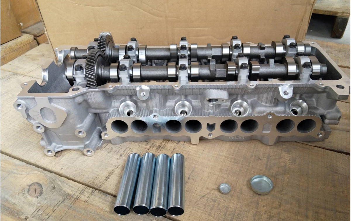Cylinder head with camshafts and rocker assembly, plus small metal parts and valve lifters
