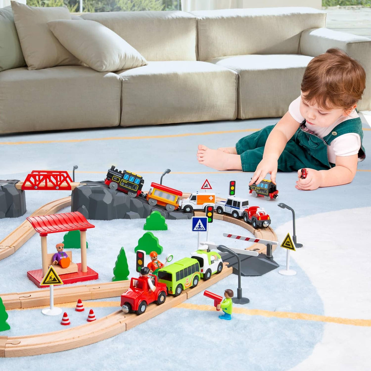 Toy train set with black locomotive and orange car on play track with vehicles
