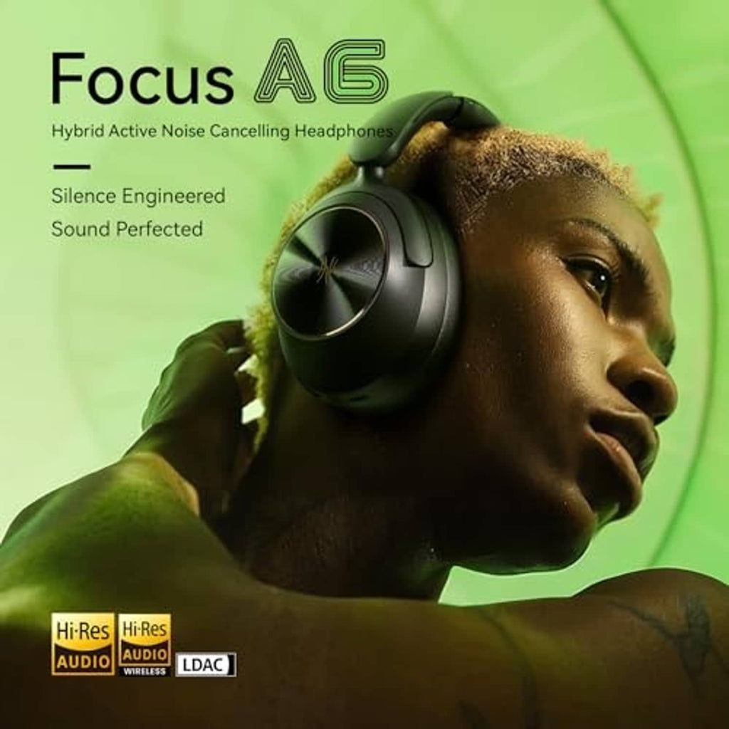 Black over-ear noise cancelling headphones resting on a person’s head with adjustable band