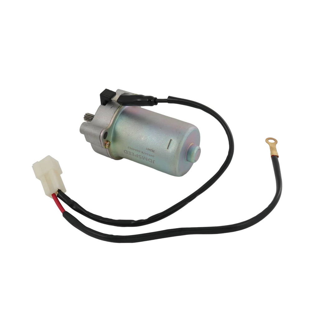 Starter motor with cylindrical housing, black wiring leads, and white electrical connector