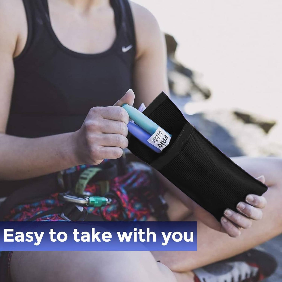 Black FRIO cooling wallet sleeve held in a hand, with insulated insert inside