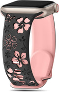 Floral engraved smartwatch band with pink flower cutouts on black, slim strap