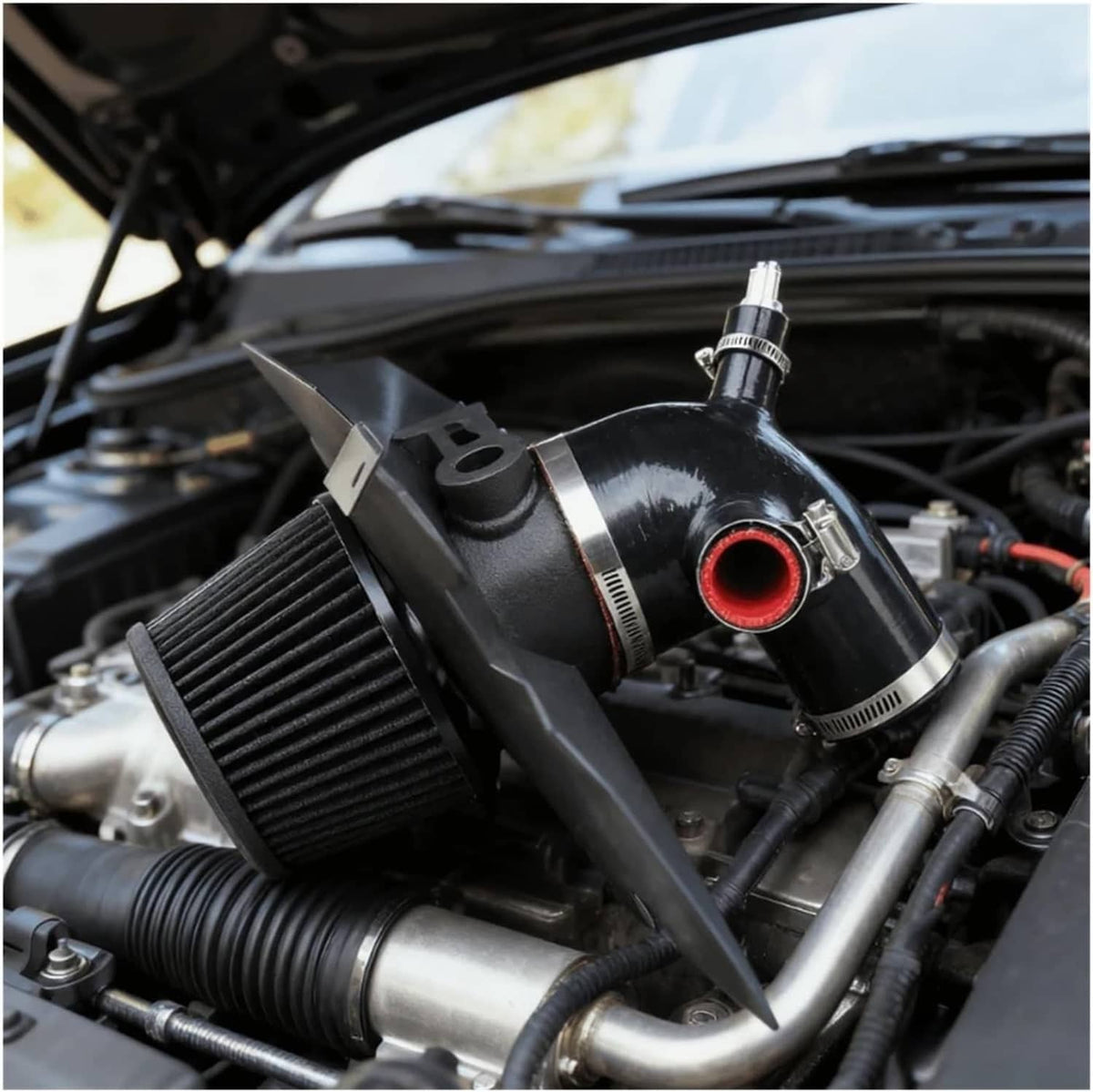Installed black cold air intake with cone filter and red-tipped outlet in engine bay