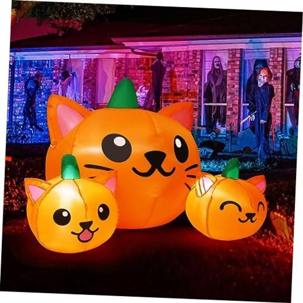 Orange inflatable cat-head trio with three green cone hats, pumpkin-style Halloween yard decor
