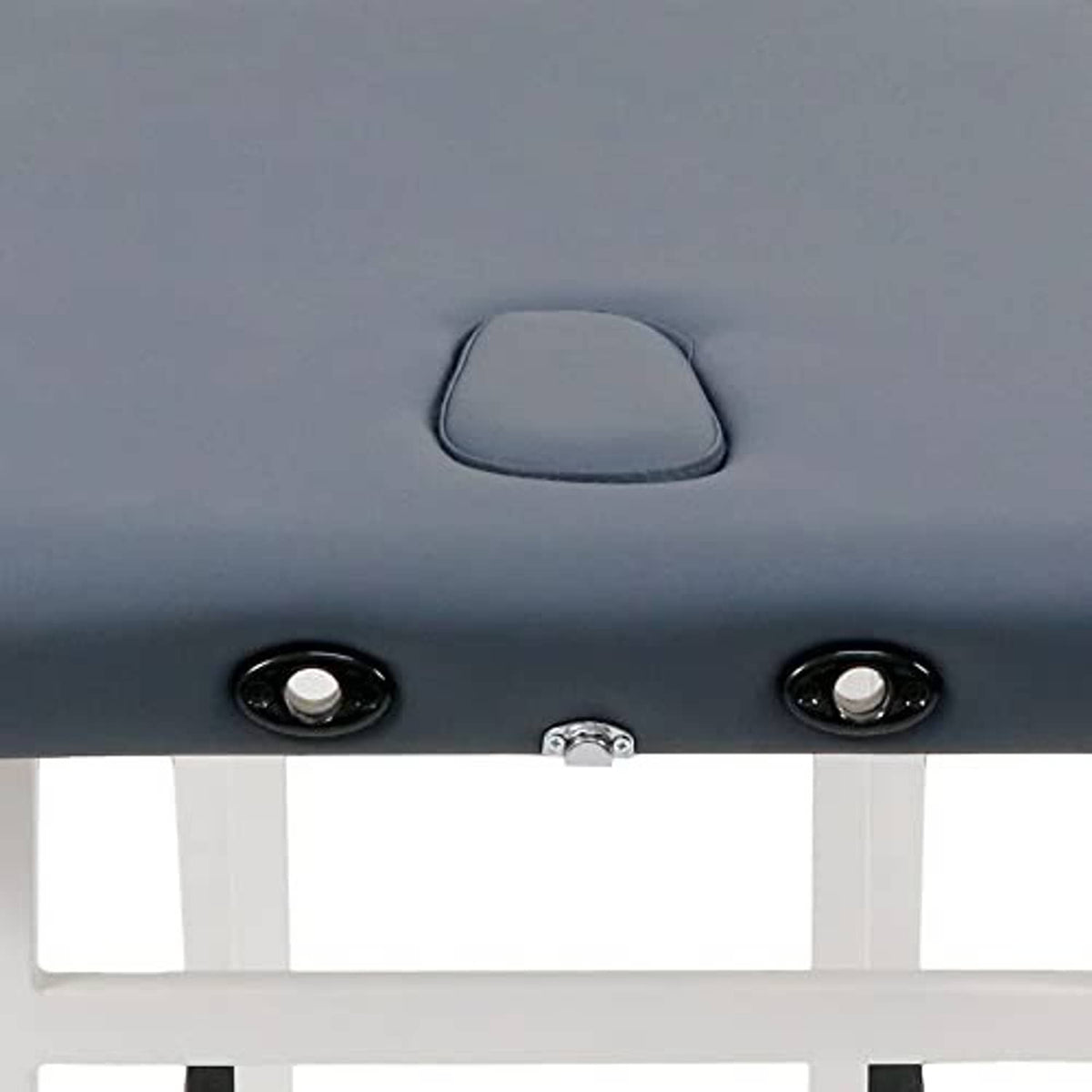 Close-up of royal blue massage table upholstery with headrest handle and metal hardware