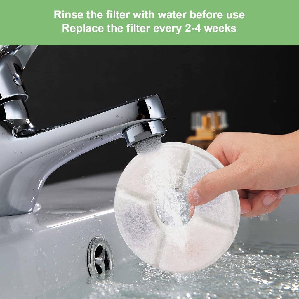 Round gray filter disc being rinsed under running water by a hand