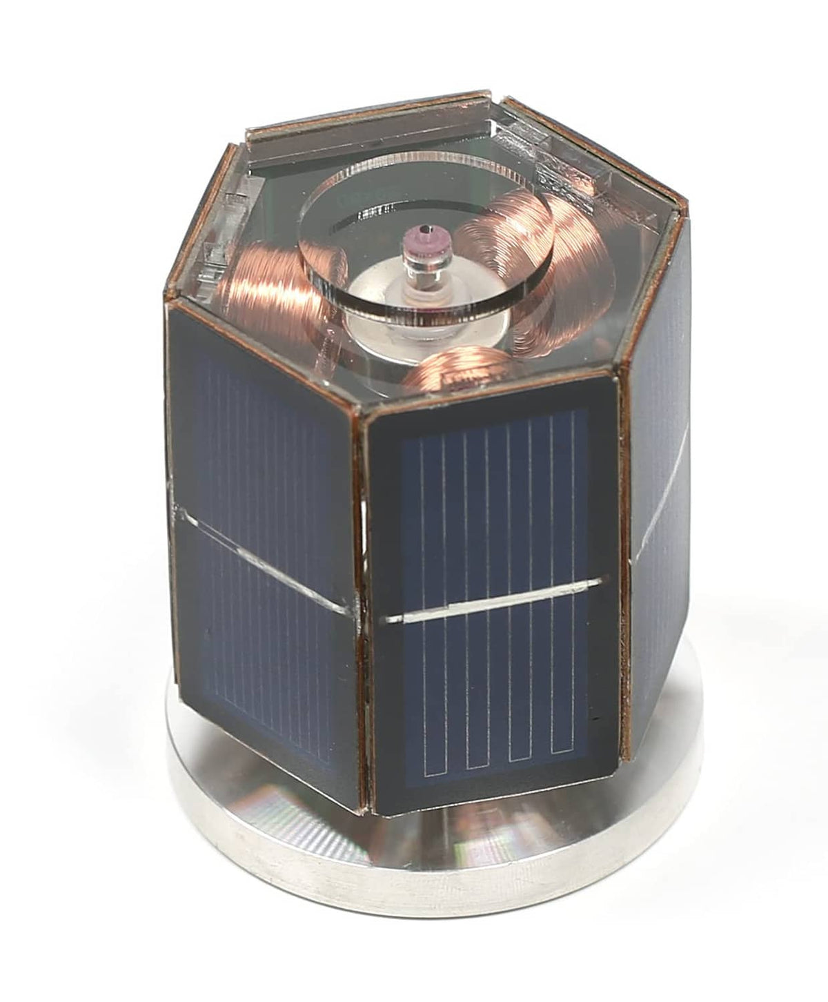 Solar motor toy cube with transparent top showing copper coil rotor and solar panels