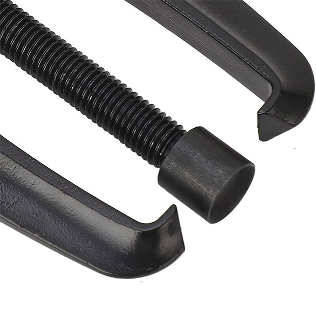 Close-up view of black puller jaws and threaded rod with textured end cap