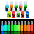 Assorted glow-in-the-dark UV resin dye bottles in teal, orange, green, and more