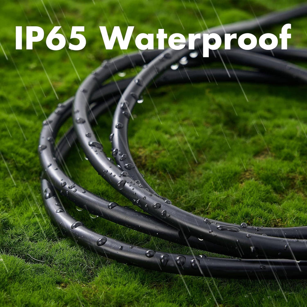 Black coiled outdoor extension cord on grass with water droplets on the cable