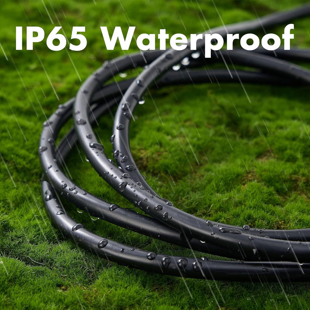Black coiled outdoor extension cord on grass with water droplets on the cable