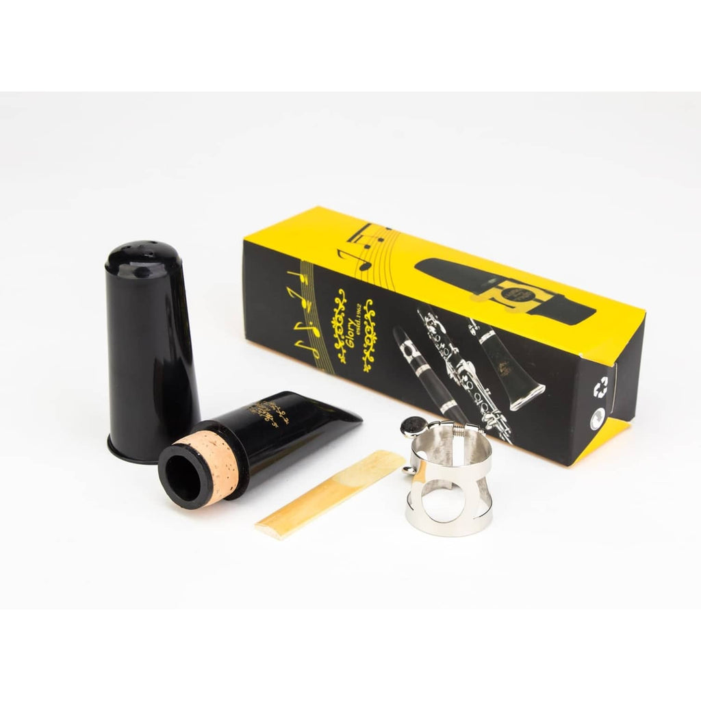 Clarinet mouthpiece kit with black mouthpiece, silver ligature, cork reed, and yellow box