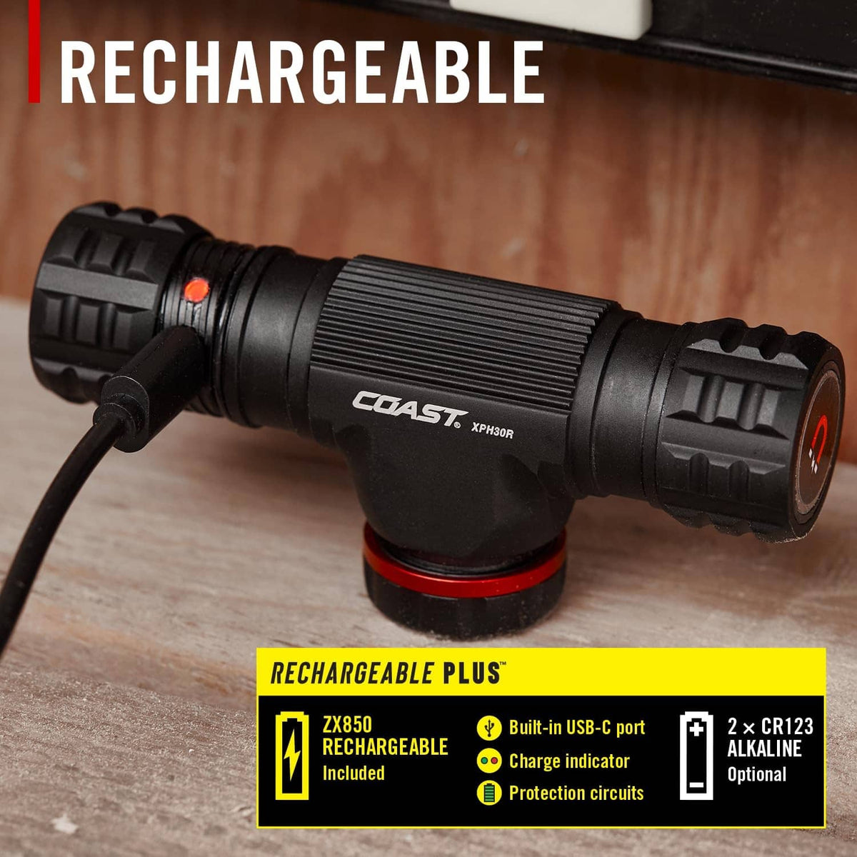 Black rechargeable headlamp flashlight body with red accents on wood