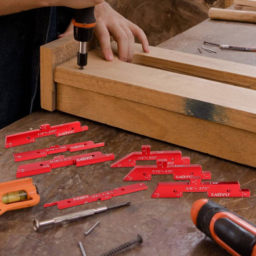 Red aluminum router setup bars and precision blocks on a workbench