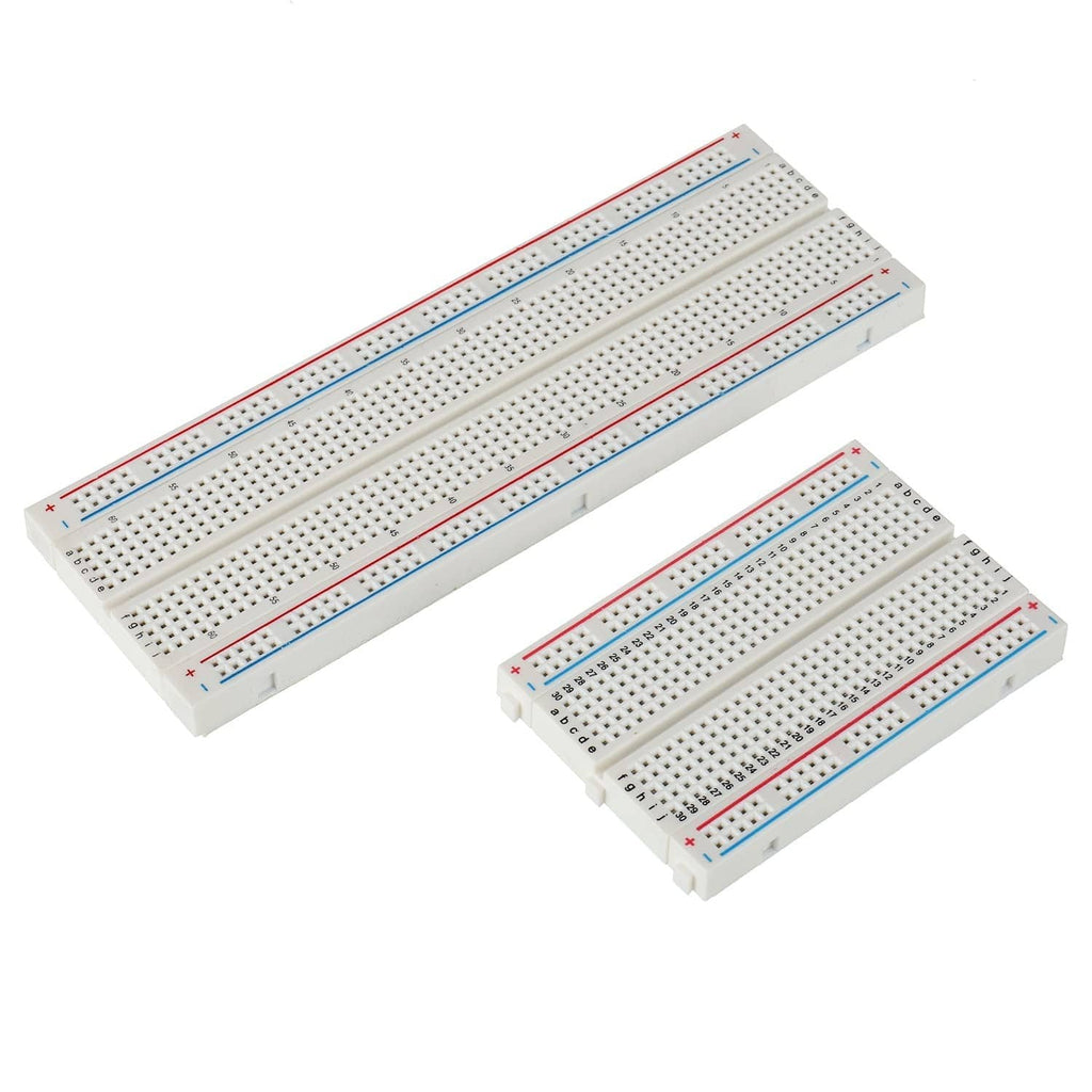 Two solderless breadboards with pin holes, red and blue signal rails