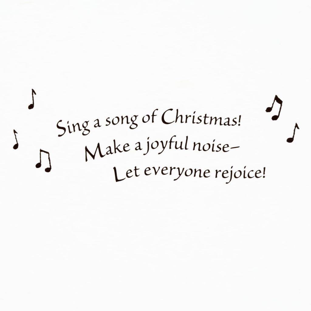 Christmas verse text on a white greeting card: “Sing a song of Christmas!”