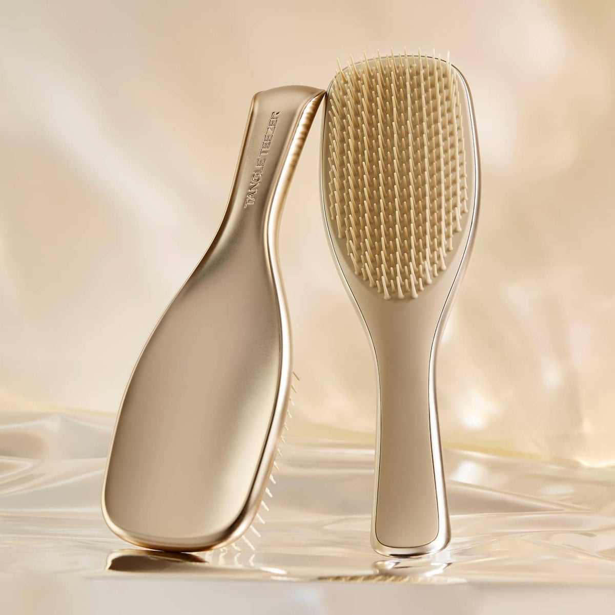 Champagne gold full-size detangling hairbrush with oval head and fine bristles
