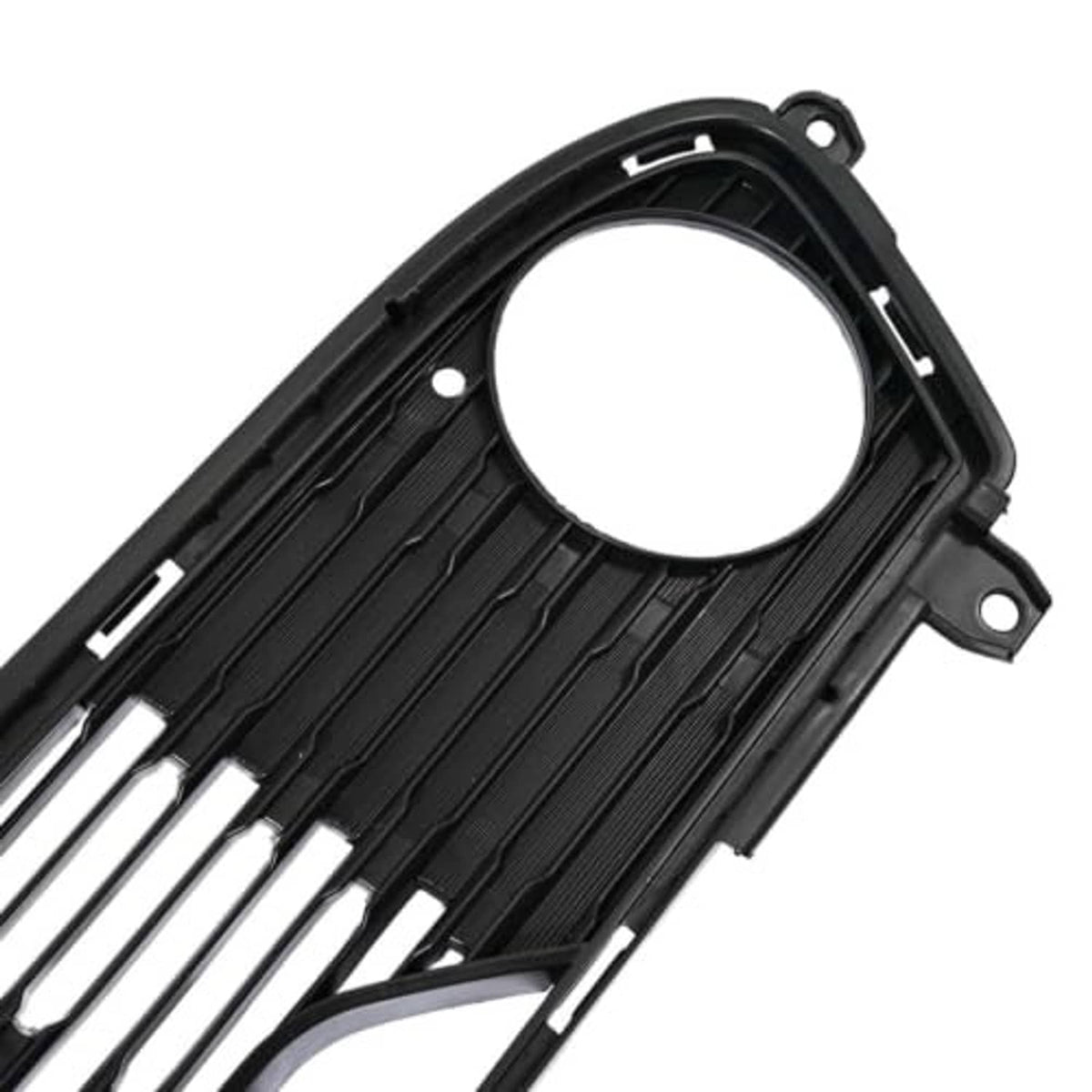 Front bumper lower grille close-up, black with round opening and ribbed slat details