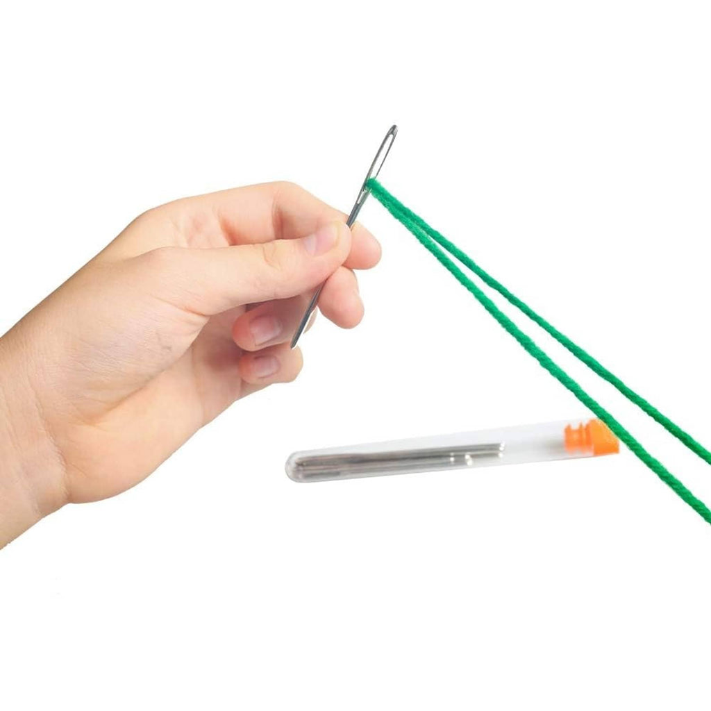 Hekisn blunt yarn needle with large eye held in hand with green yarn