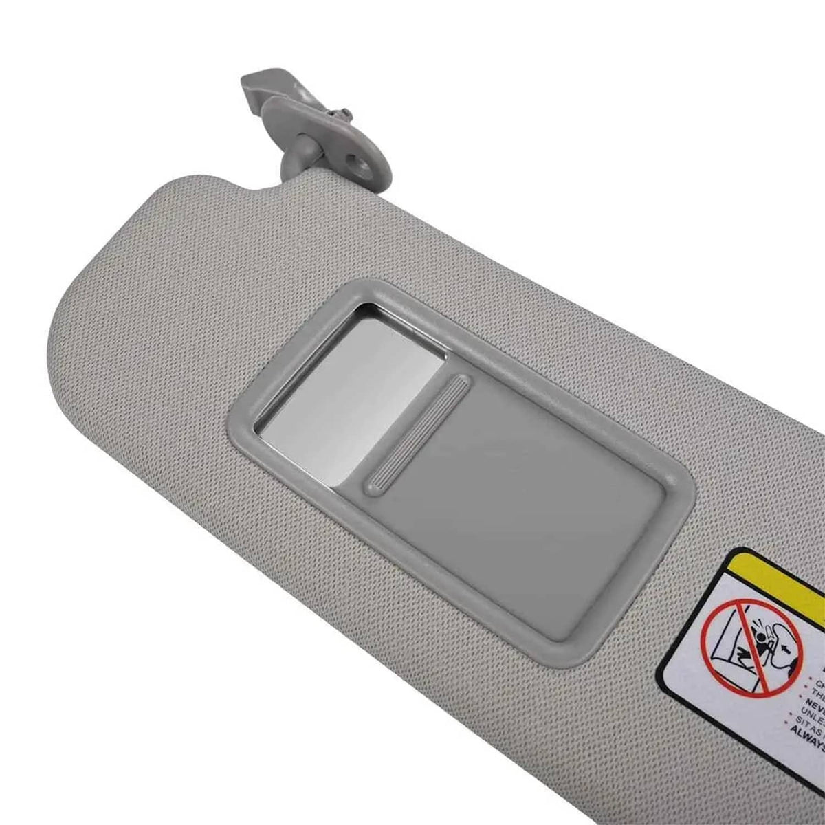 Grey sun visor angled view showing vanity mirror glass and warning sticker