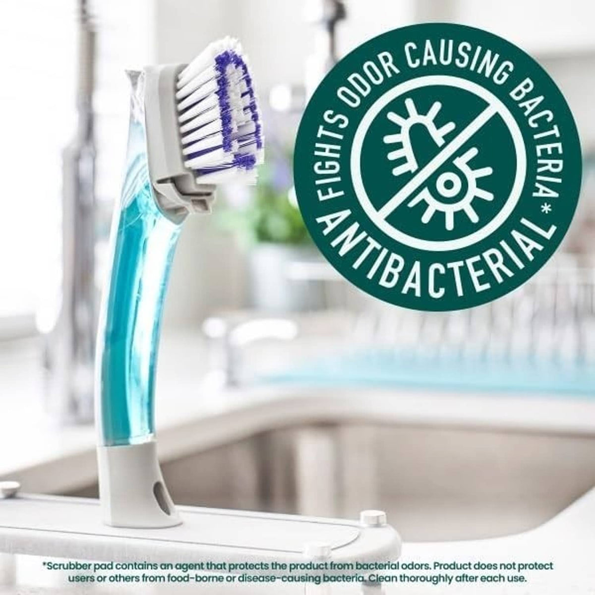 Dish brush on sink with blue bristles and antibacterial protection seal
