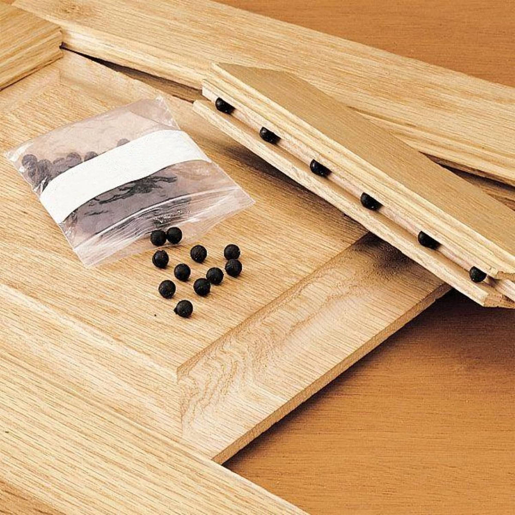 Set of black rubber balls and spacer pieces for cabinet door alignment