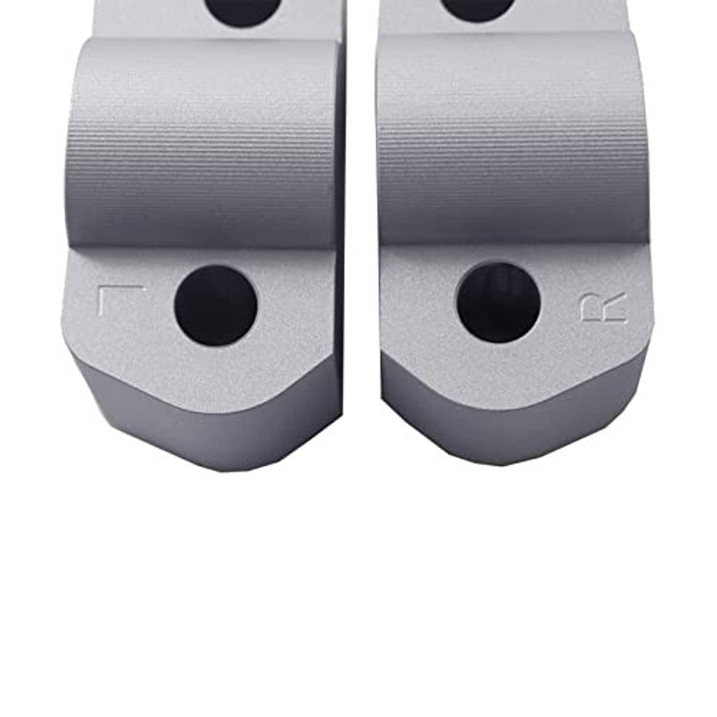 Silver CNC aluminum riser bases with large circular mounting holes and engraved mark